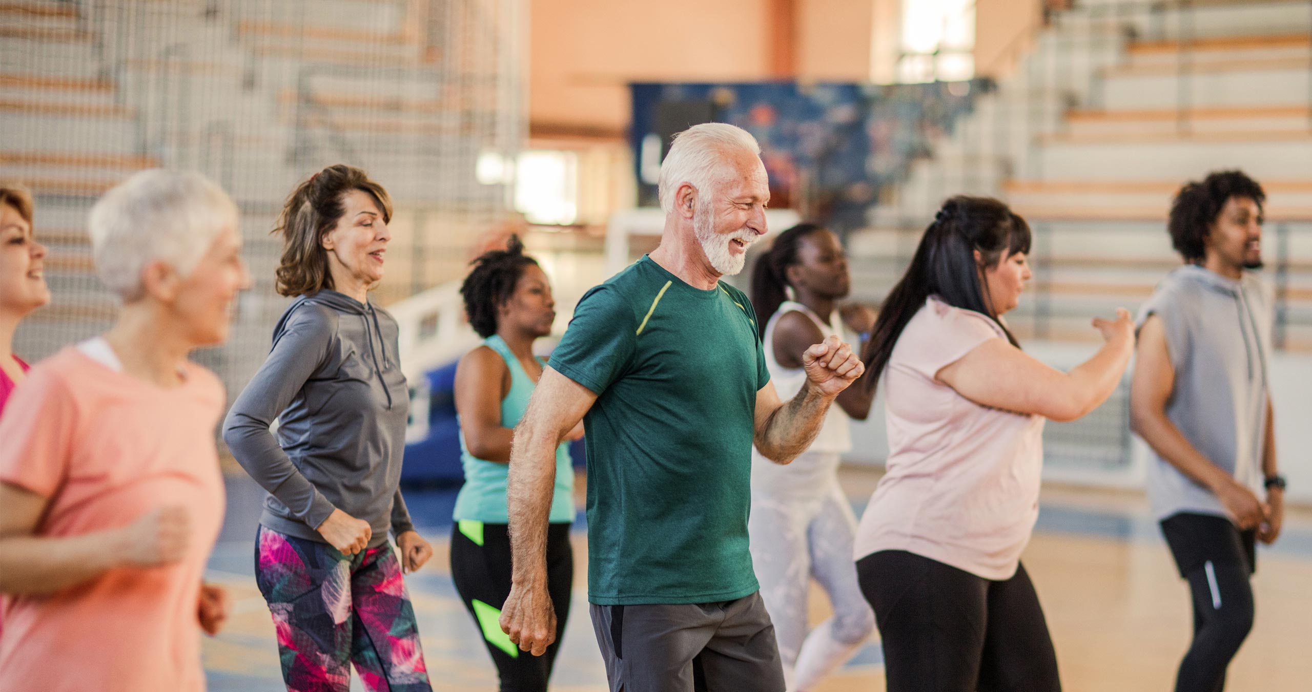 People of diverse cultures and ages enjoying an exercise class.